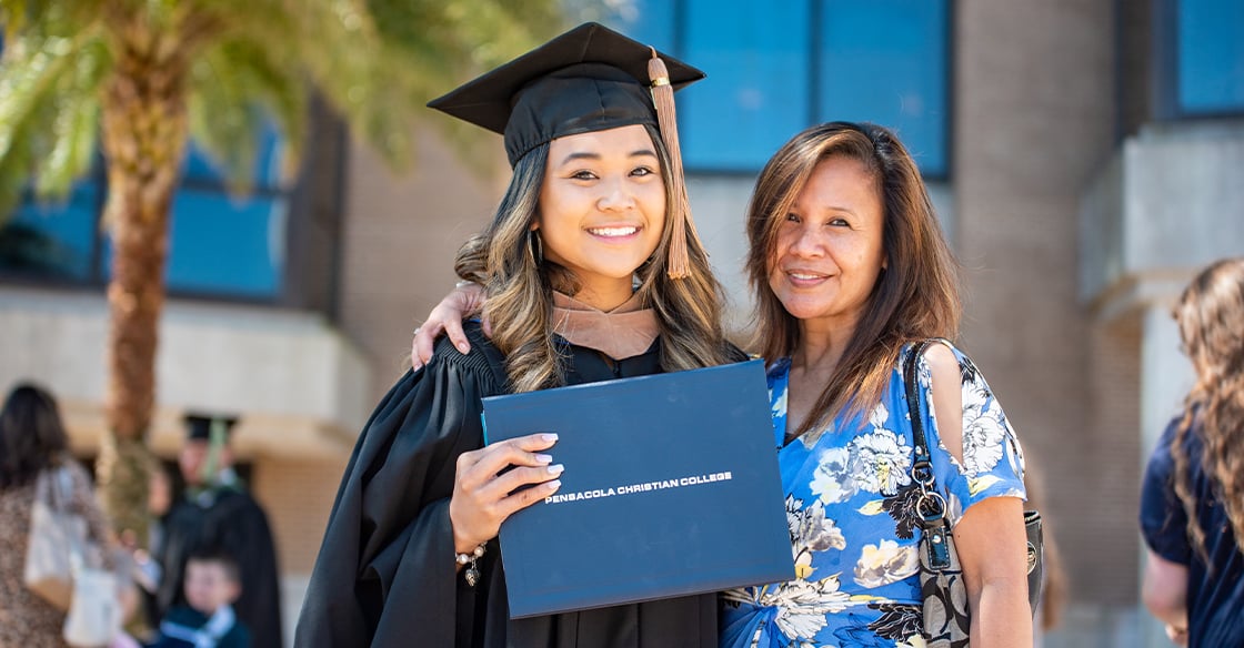 Graduate smiling with mom