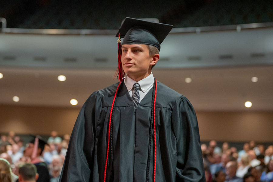 Graduate walking down aisle