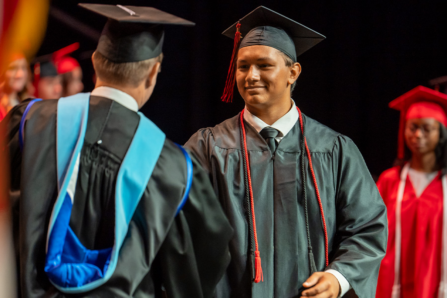 Graduate shaking hands