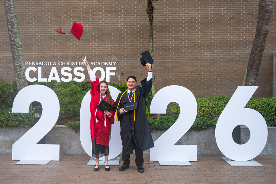 Graduates with class sign