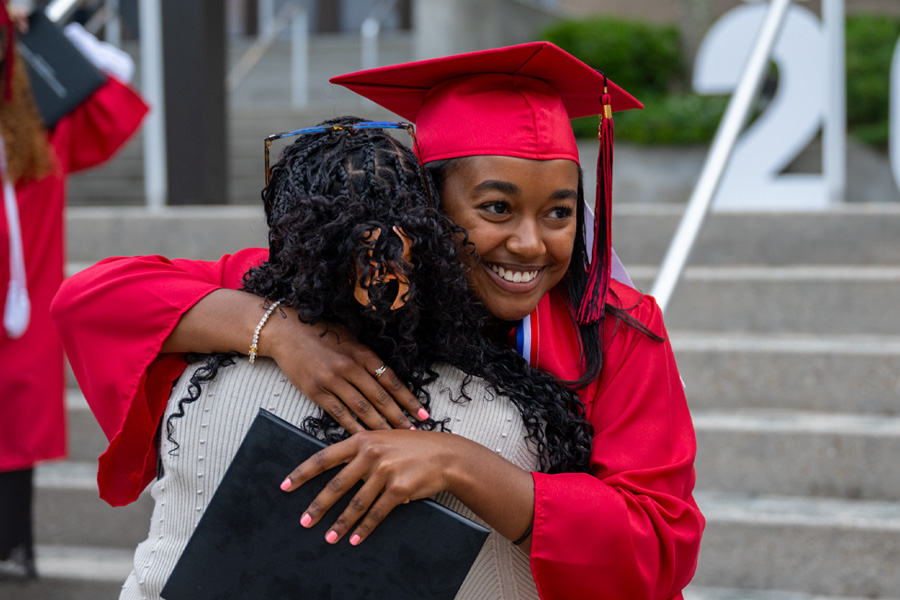 Graduate hugging family