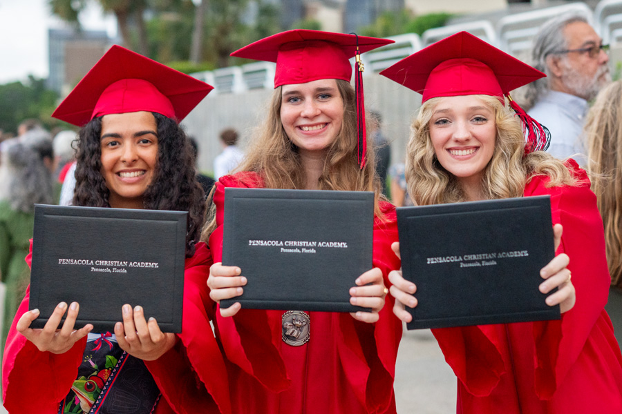 Graduates holding diplomas