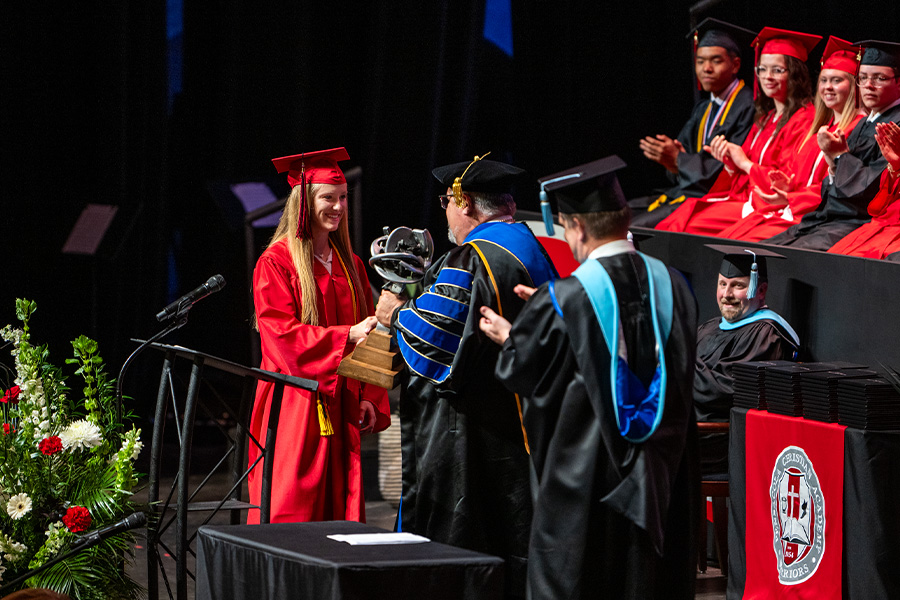 Graduate shaking hands on stage