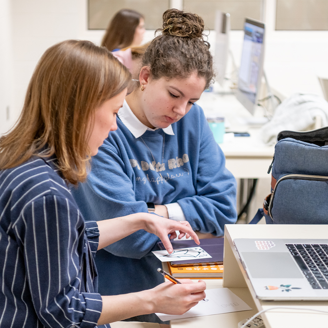 Student sketching in design class