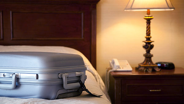 Suitcase on a hotel bed