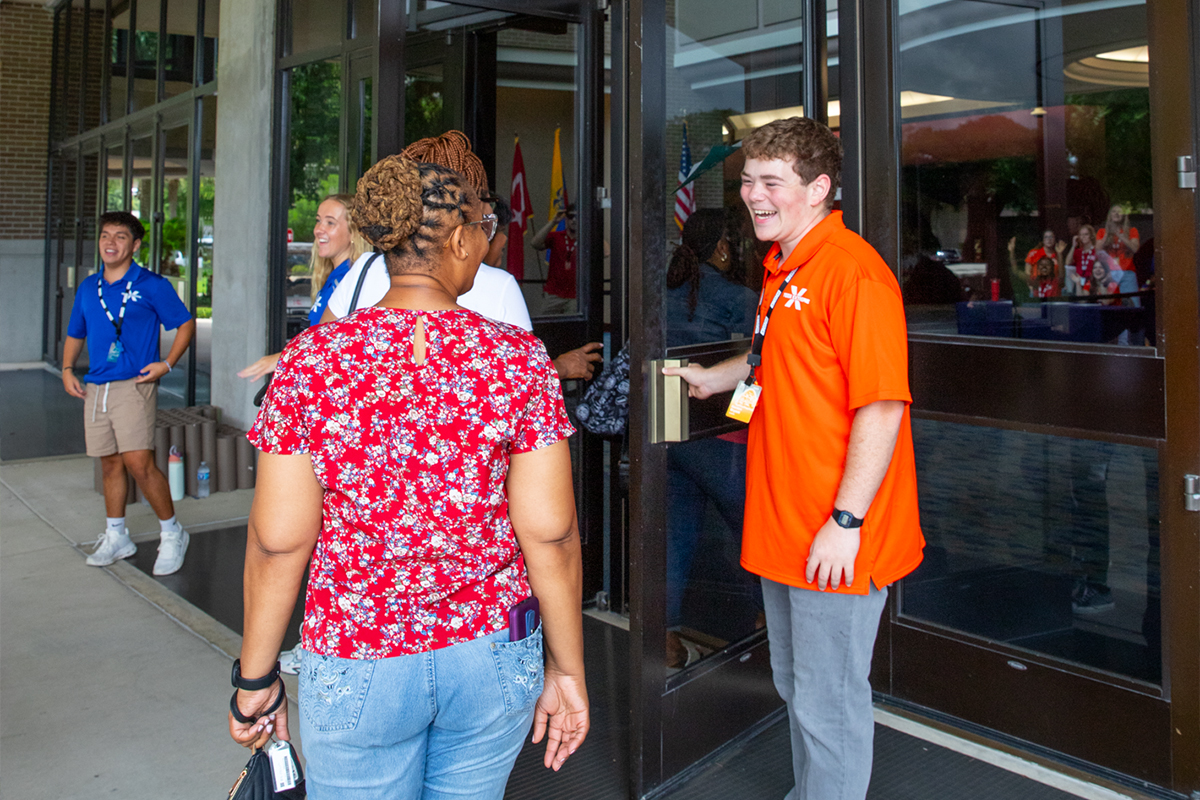 Orange team camp staff opens door