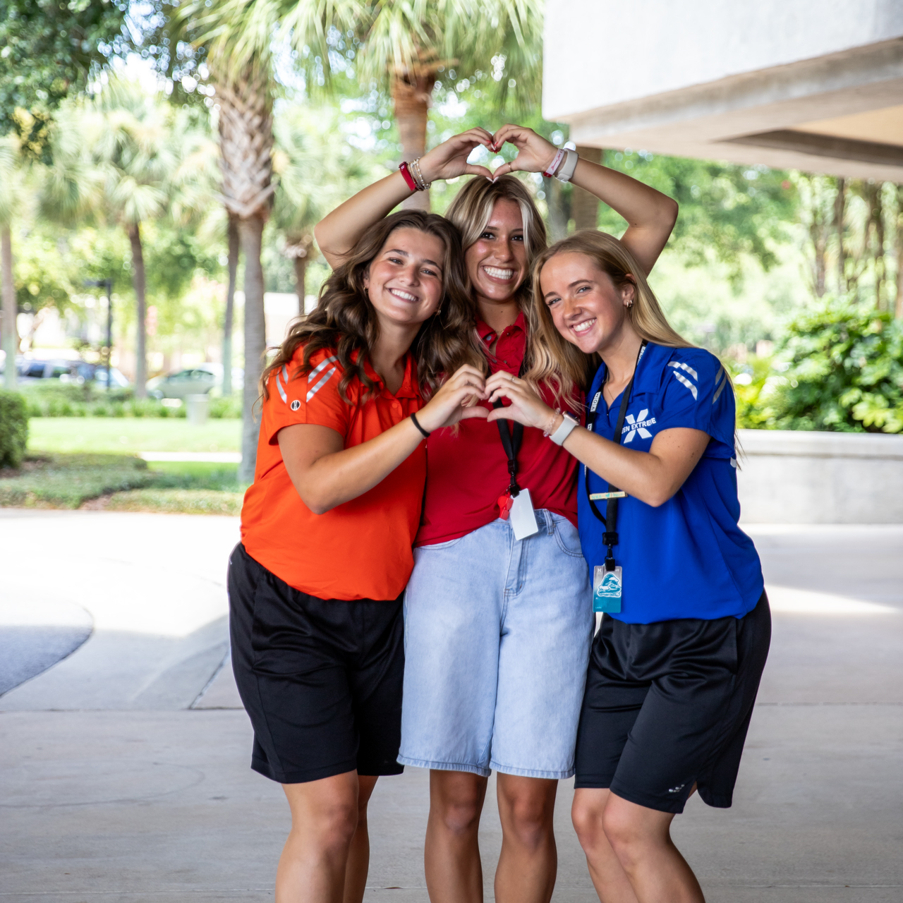 Female Camp staff posing with heart hands