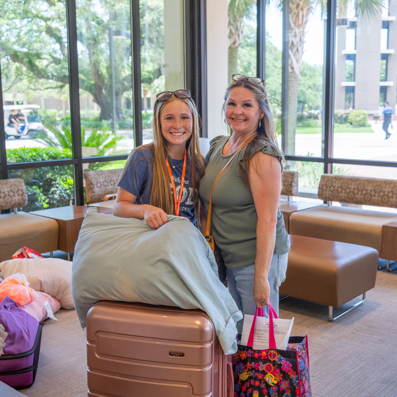 Campers and sponsor moving into residence hall