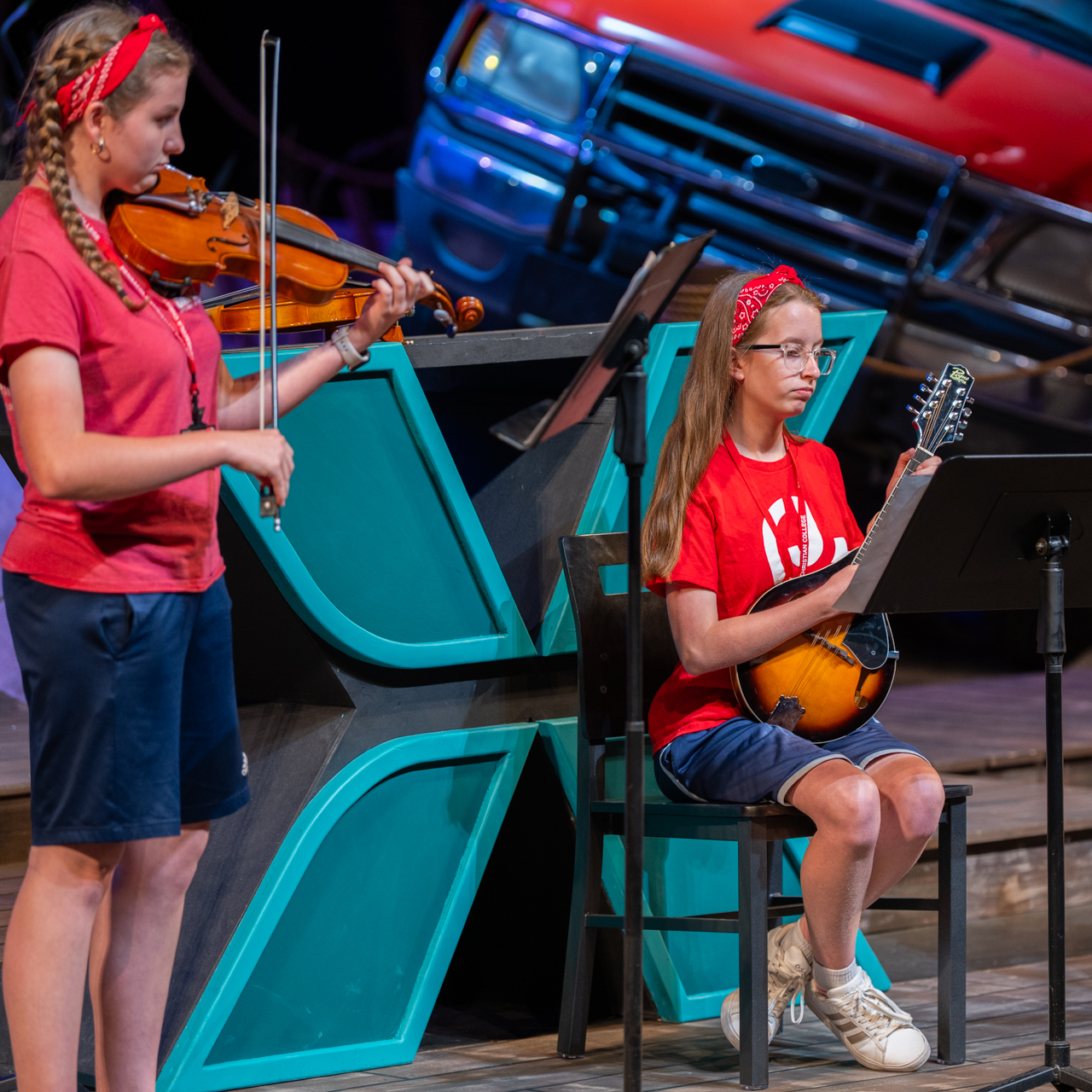 Camper trio singing and playing the piano