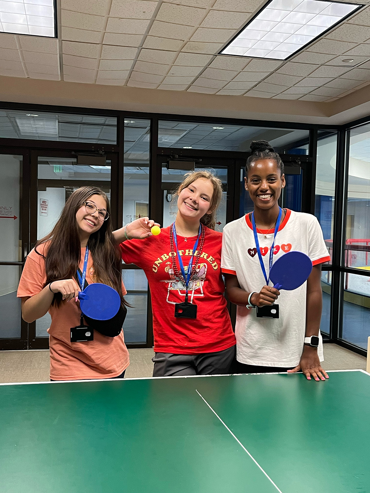 Teen Extreme girl campers playing ping pong
