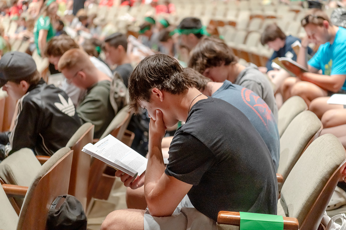Teen Extreme camper reading in chapel