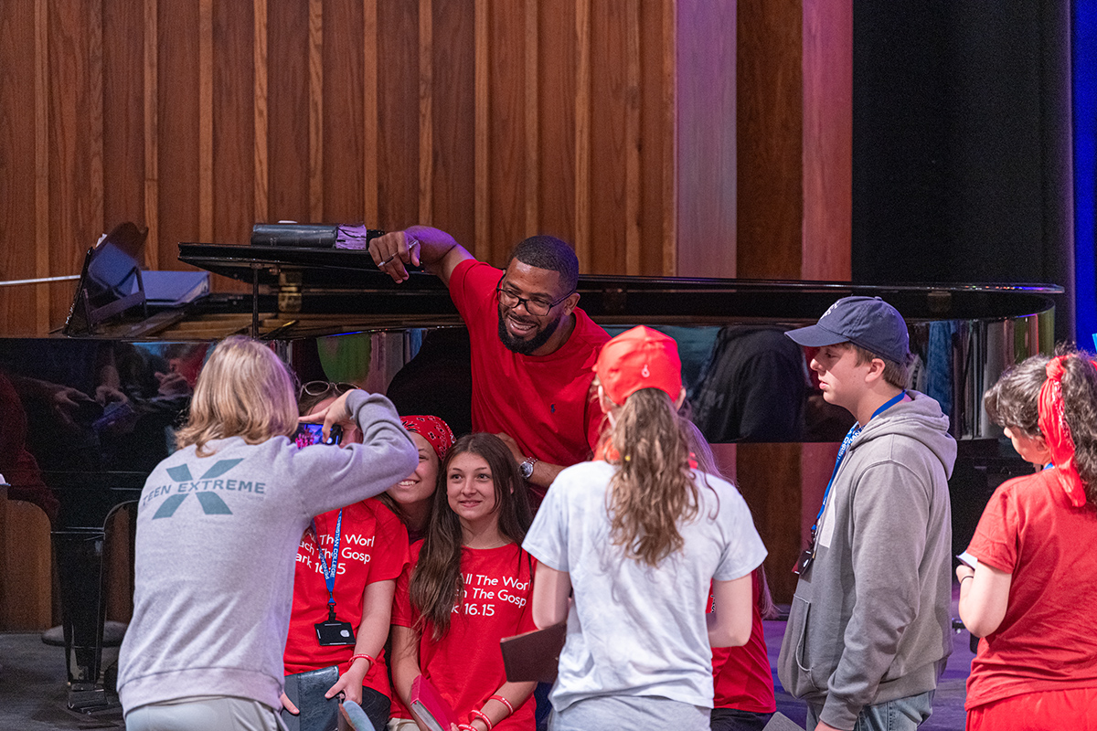 Teen Extreme campers taking picture with speaker Dr. Kenny Baldwin